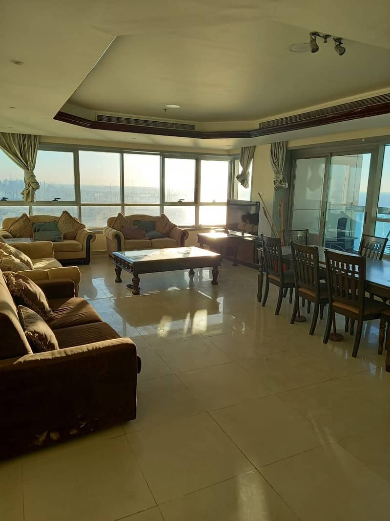 SPACIOUS CITY AND SEA VIEW TWO BEDROOMS PLUS HALL APARTMENT WITH FREE CHILLER A/C, 3 BATHROOMS, BALCONY AND PARKING IN CORNICHE TOWER ONLY 45000 IN 4 CHEQUES.