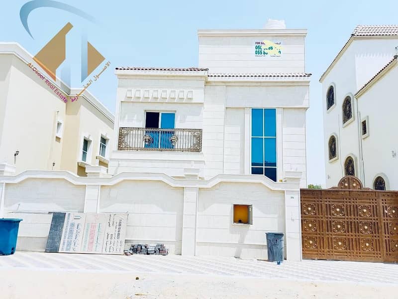For sale, a villa in Ajman, facing a stone, on a street, without initial payment, and in monthly installments for a period of 25 years, with a large bank indulgence