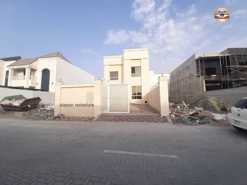 Villa for sale in Ajman, Al-Yasmeen area, with a stone face on a straight street, with the possibility of easy bank financing