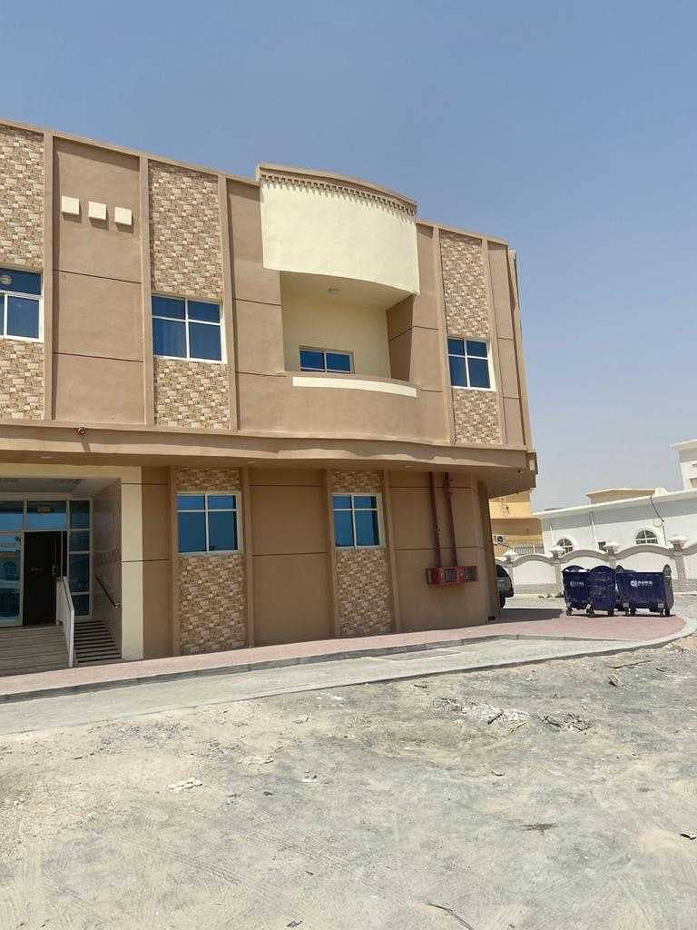 A new building in Al Mowaihat for annual rent with one-room apartments, a hall and studios