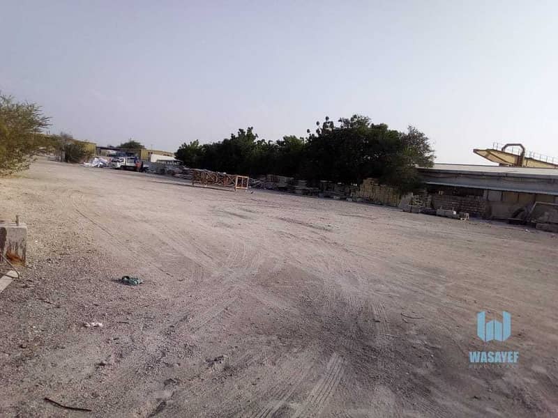 14 HUGE PLOT WITH A LARGE WAREHOUSE FOR RENT /10AED PER SQFT. .