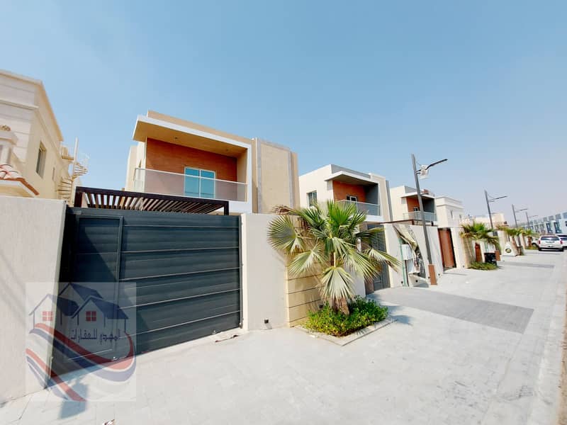 For sale, a villa with a stone face, high quality finishes, two floors, freehold for all nationalities, on Sheikh Mohammed bin Zayed Street directly