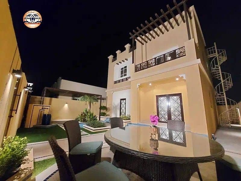The location of the villa in Ajman is Al Zahia area, two floors, on a straight street, with different finishes, fully furnished, and air conditioners,