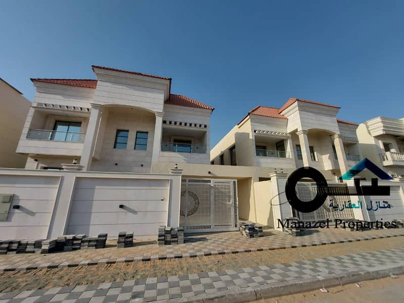 Villa for sale in Telal Al Alya close to services. The villa is European design covered with white stone, located on a neighboring street.