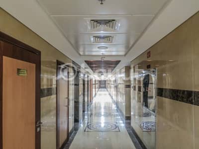 Shop for Rent in Al Jurf, Ajman - Shops for rent overlooking Sheikh Ammar Street - inside a large residential building 200 units - new building - two months free - without commission