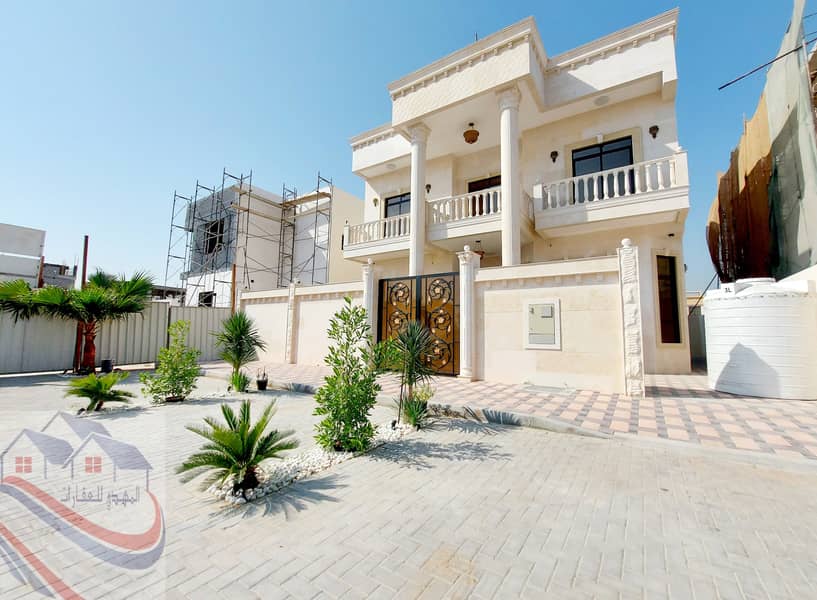 A new upscale villa with a modern design for sale in Ajman, personal finishing, central air conditioning, on a main street