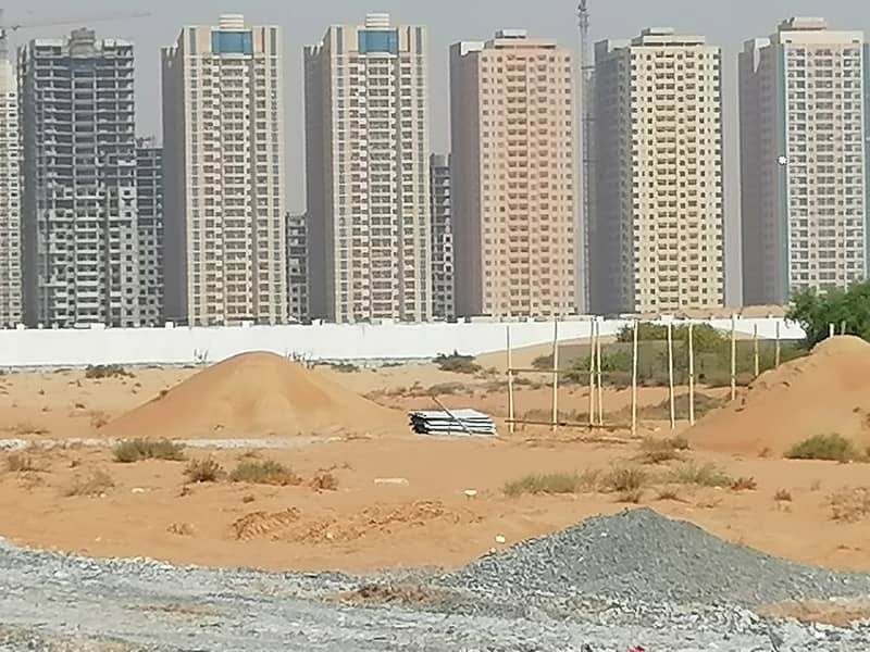 A plot of land for sale in Al-Alia area on Sheikh Mohammed bin Zayed Street, residential and commercial, excellent location.