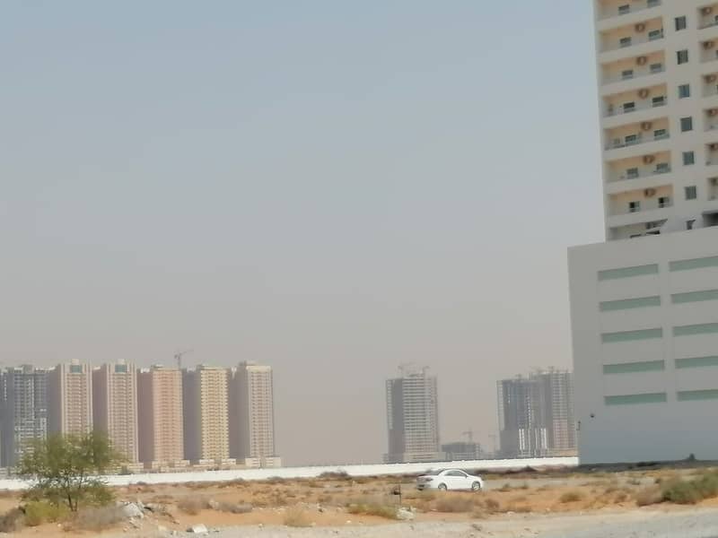 Land for sale in Al Amerah area, Ajman, residential and investment, the land next to Al Watan University and Fam Holding ** Smart Tower ** a minute aw