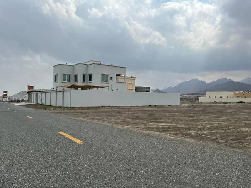 For sale, two plots of land next to each other, a large area, in Masfoot district, Ajman