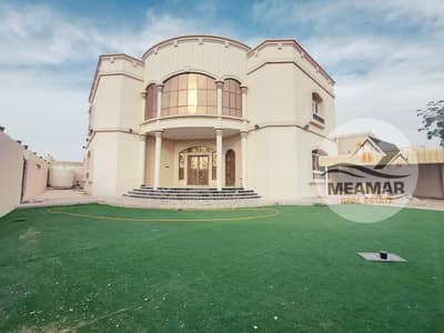 Villa for rent in Al Hamidiya area, two floors, 6 rooms, a council, a hall, and a maid room. The villa is on the corner of two streets in front of a m