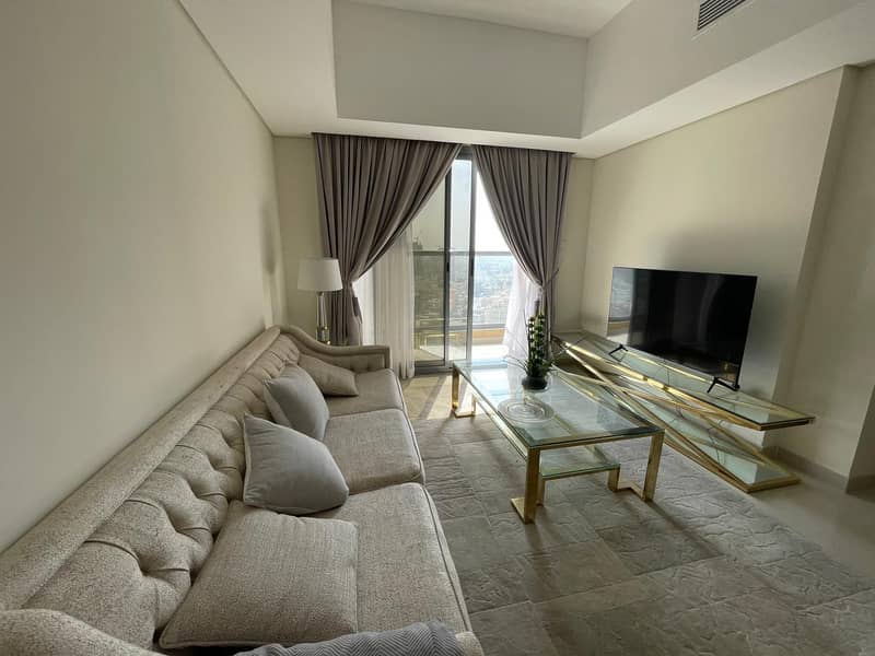 Own an apartment and live immediately in the latest tower in Ajman near Dubai, down payment from 19 thousand without fees or commissions with free par