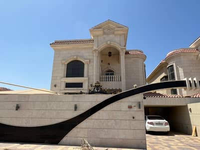 Two-storey villa with a stone front on the asphalt street for rent in Ajman
