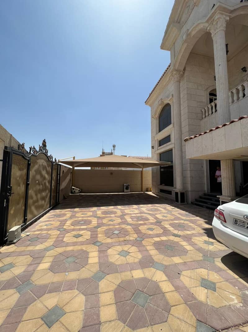 Two-storey villa with a stone front on the asphalt street for rent in Ajman