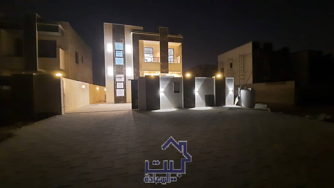 Villa for sale, Ajman, Jasmine, 3 master rooms, a board, a hall, a kitchen, and a large patio, freehold for all nationalities on an asphalt street, in