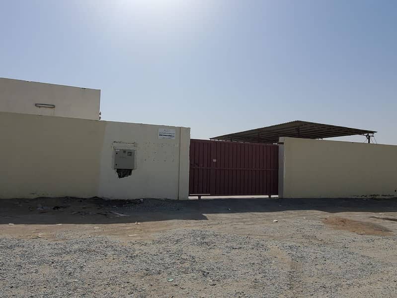 For sale in Sharjah / Al Saja'a Industrial Area, a walled industrial land with electricity and an office