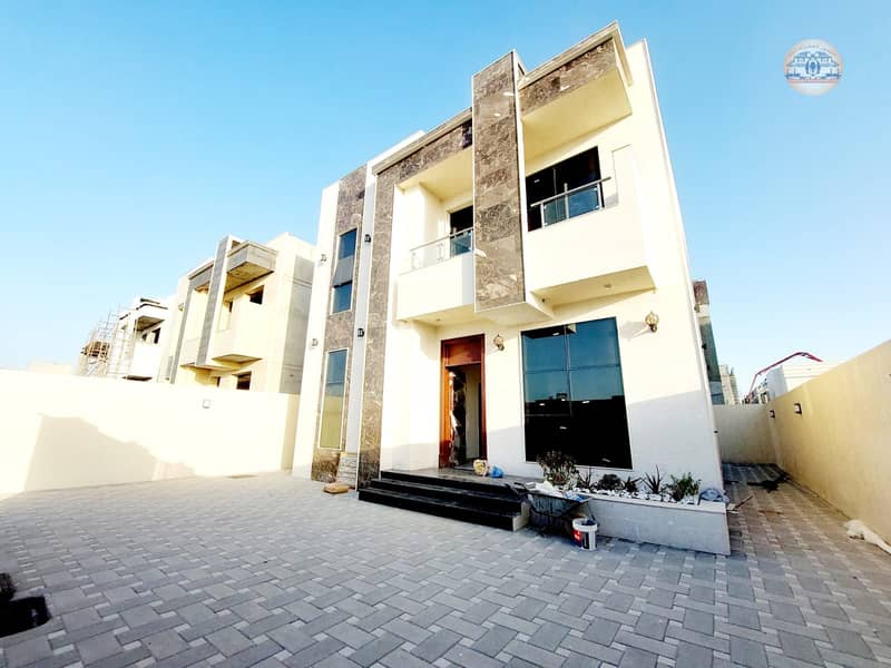 With registration and ownership fees, a villa in Ajman, the Jasmine area, two floors, facing a stone on a direct street, central air conditioning, and