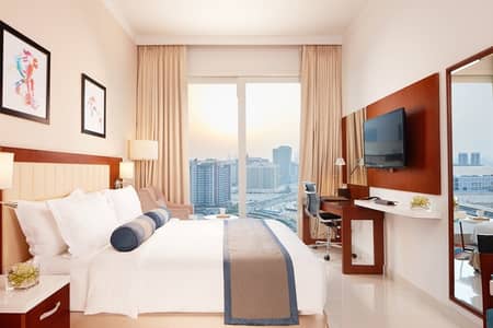 شقة فندقية  للايجار في مدينة دبي الرياضية، دبي - شقة فندقية في فندق وأجنحة تريبان من فخرالدين مدينة دبي الرياضية 66000 درهم - 6034355