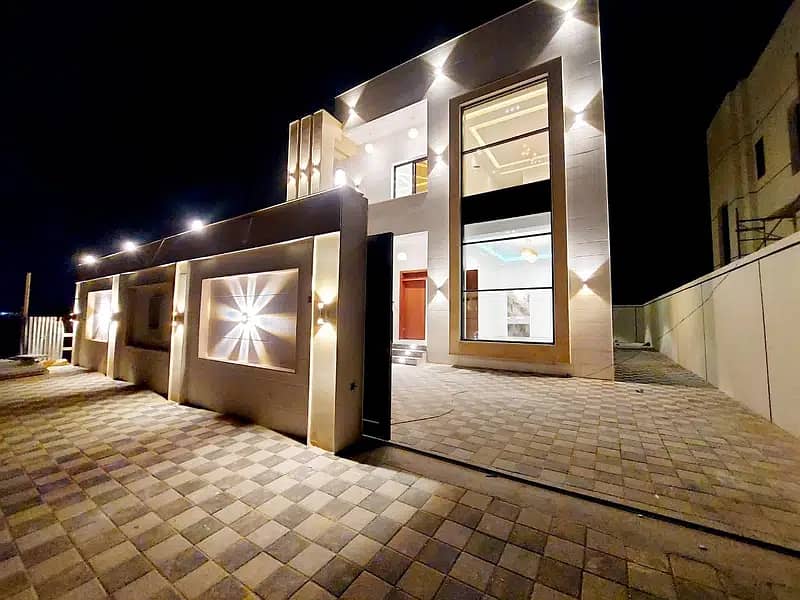 Opposite the mosque, at the price of a modern stone-faced villa, one of the most luxurious Ajman villas, with the design of Jumeirah Dubai, and the co