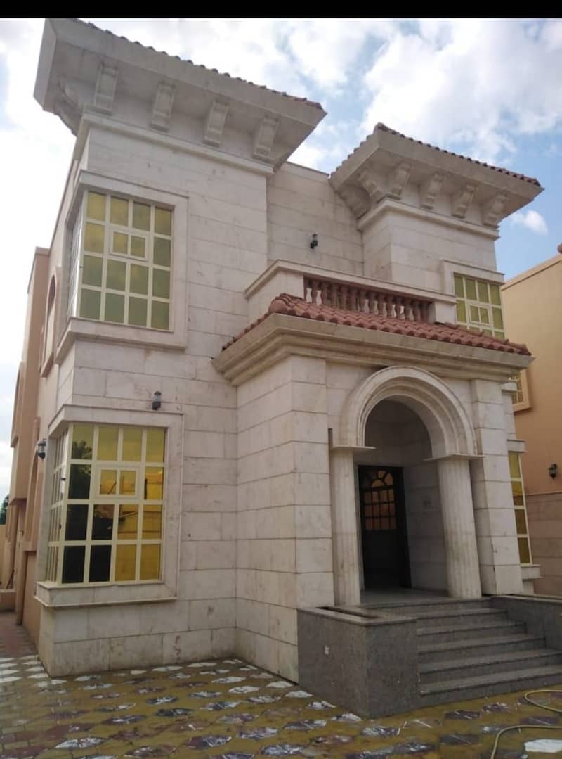 Villa for sale in Ajman, Al-Rawda area, with electricity and water, a full stone front, of ​​4300