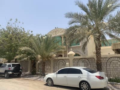 For rent Al Ramaqia villa, Sharjah, two floors, 9 rooms, a hall, and a coun