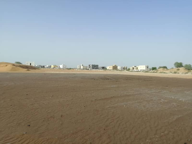 Residential investment land for sale in Al helio 2 area Ajman, zero fees, Asphalt street, freehold for all nationalities.