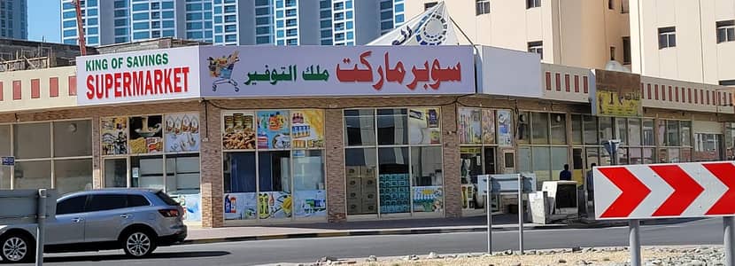 Shop for Rent in Al Rumaila, Ajman - Shops for rent, a main street in Al Rumaila