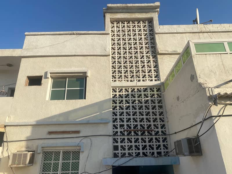 Residential and commercial building corner on main street in Ghafia