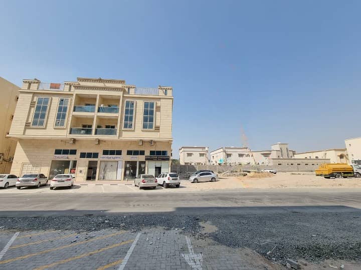 Residential commercial land G+2 Ajman Al Muwaihat, third plot from the main Al Talla Street