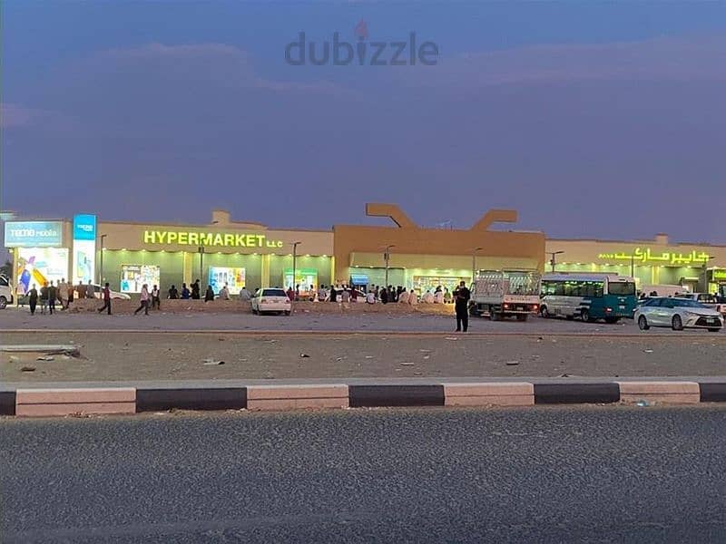 land for sale in al sajaa with labor camps and hypermarket