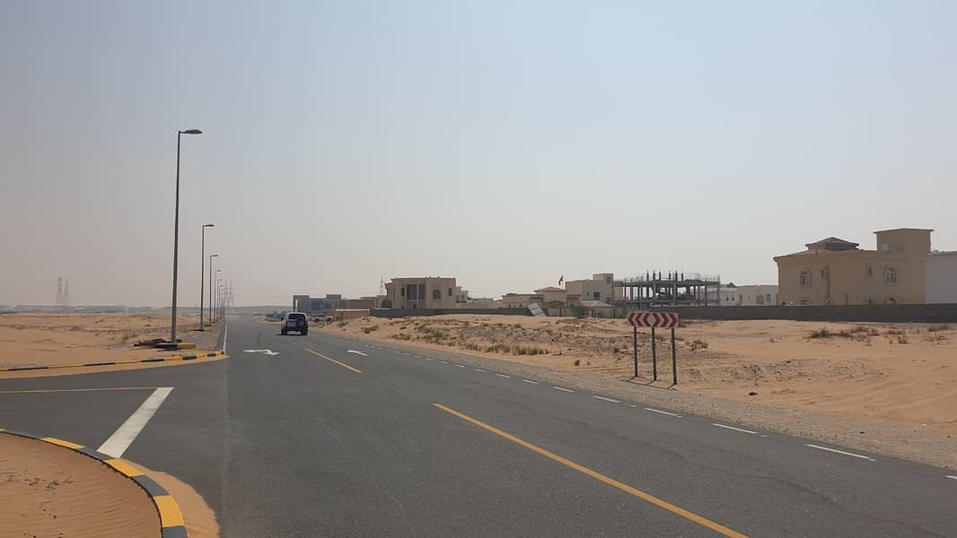 Own in Sharjah, in the Zubair Orchards project, residential land in installments over 3 years