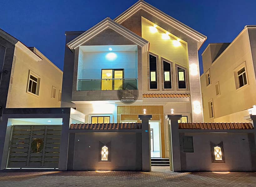At a snapshot price and without down payment, a personal design villa behind Al Helio Park, one of the most luxurious villas in Ajman, with a super de