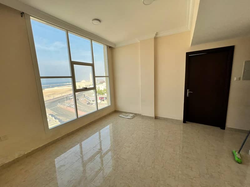 A room and a hall directly on the Ajman walkway, with a full view of the sea