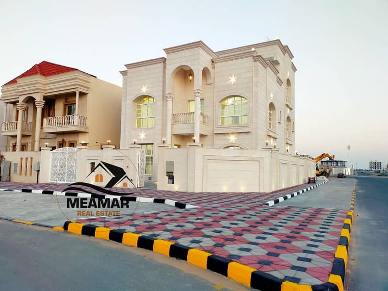 Villa for sale in Ajman, on an area of ​​4,700 feet, the corner of two streets, 7 master rooms, freehold for all nationalities, and it has attention,
