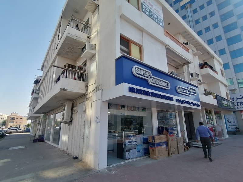 For sale, a two-storey building, directly opposite the Ajman Tourist Walk