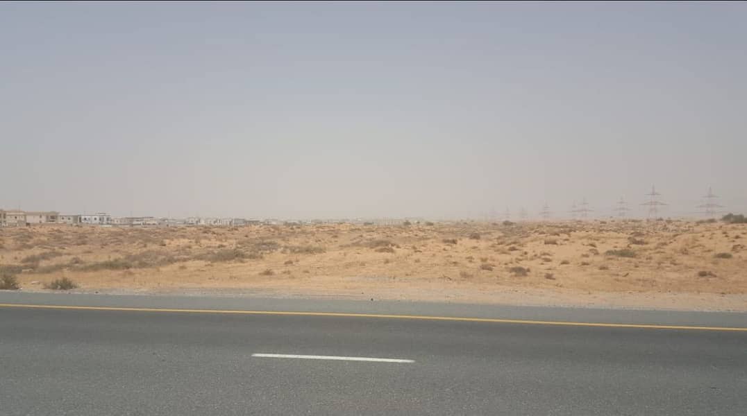 Land for sale in installments for three years, including fees and registration, in Sharjah, Al Zubair area, opposite Al Rahmaniyah