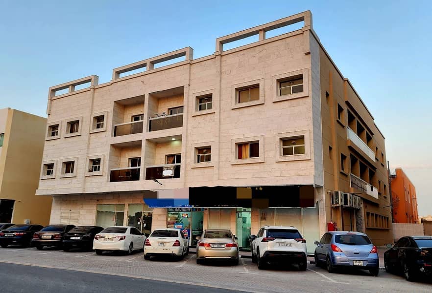 A building for sale, residential and commercial, on a main street in Al Rawda 3.