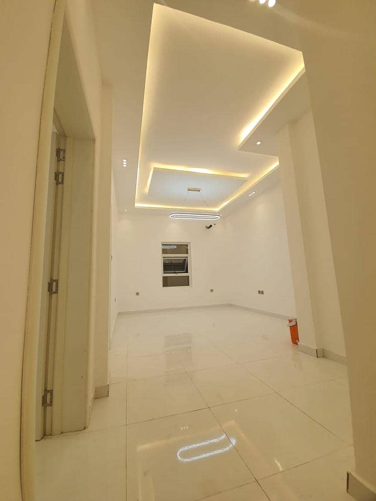 For rent in Ajman, a residential villa in the Al-Zahia area, consisting of two floors, 4 master rooms, and a hall, a very large area, with a large cou