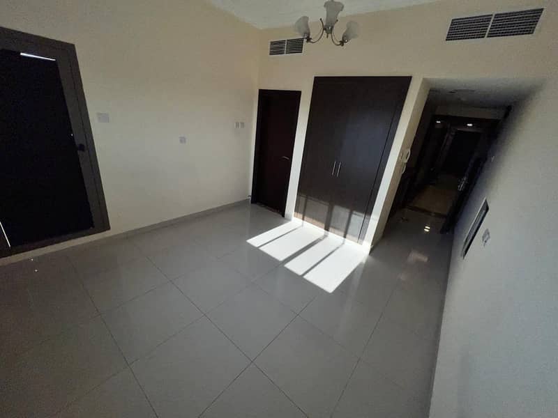 For rent in Ajman, a large studio with cabinets in the walls, with a balcony in Al Rawda 1, behind Al Hamidiya Police