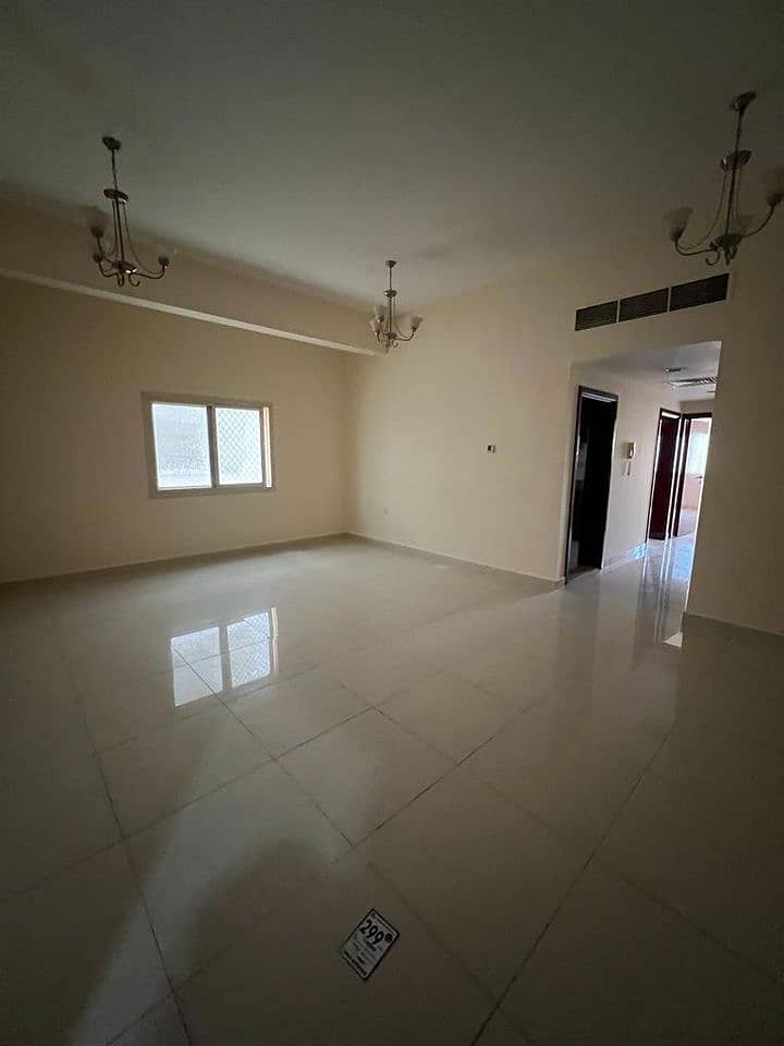 For rent in Ajman, two-room apartment and a large hall, clean building, next to Al-Hikma School, Al-Ittihad Street