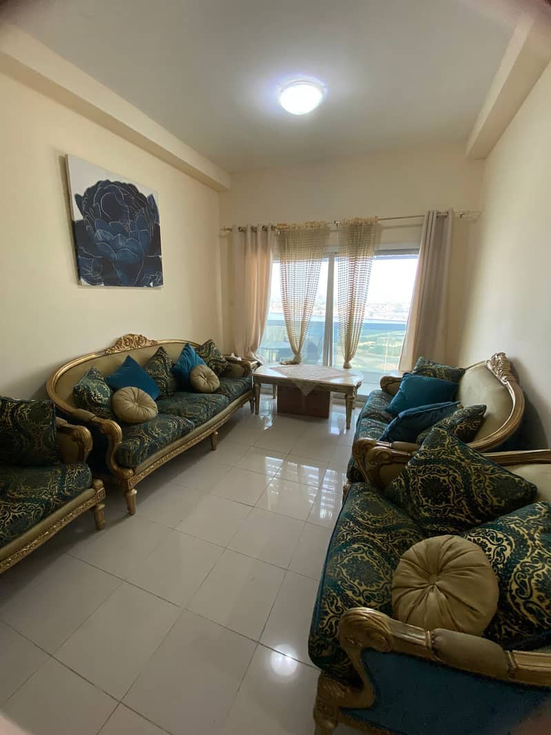 Two rooms and a hall furnished for rent Ajman Pearl Towers area 1280 feet overlooking the creek