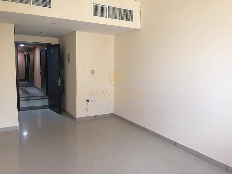 Huge and Bright 1BR | Covered Parking in 12 Cheqs | Al Taawun