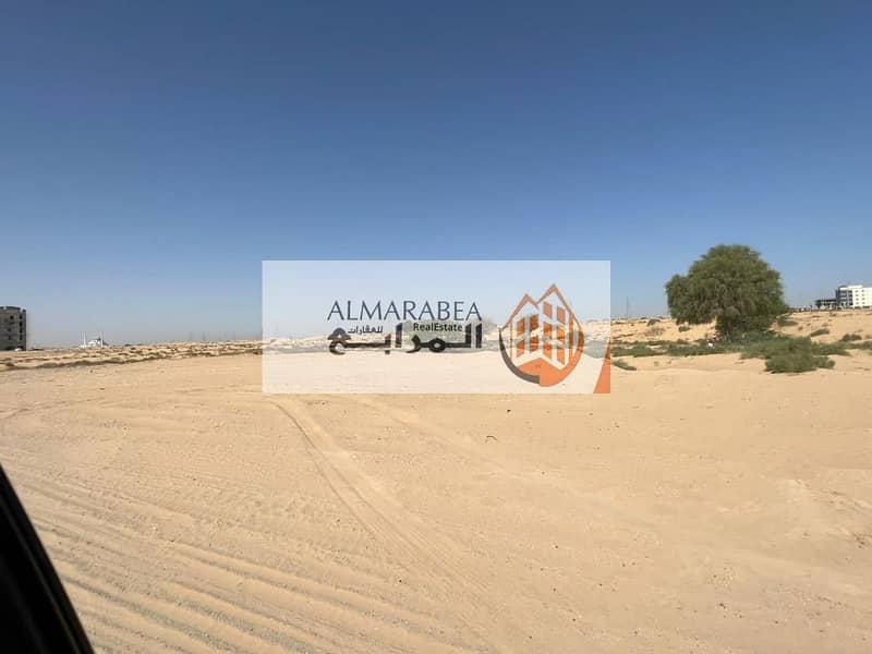 Commercial land for sale in Al Raqiba area, Al Suyouh suburb behind the Tilal project