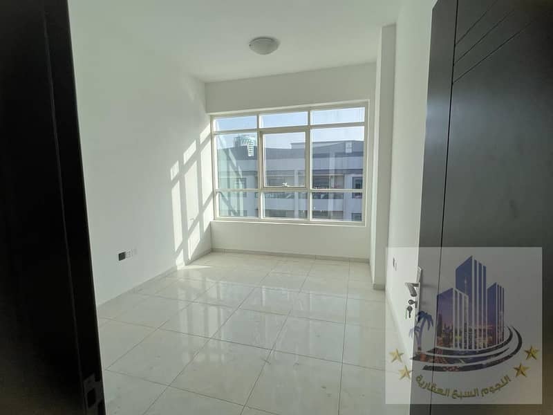 For rent in Ajman, two rooms, an annual hall, with a balcony, a wonderful view of the main street in the Al-Nakhil area, an excellent area apartment w