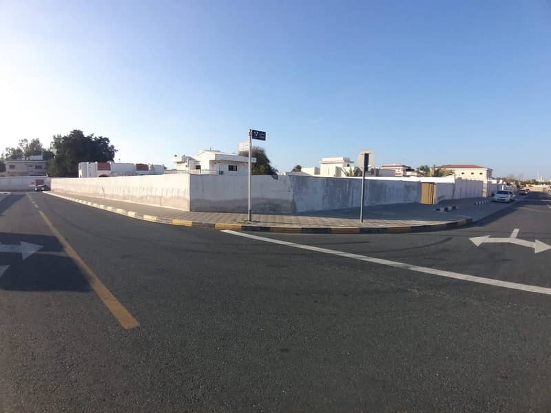 For sale walled corner land in Sharjah / Al Khuzamiya area