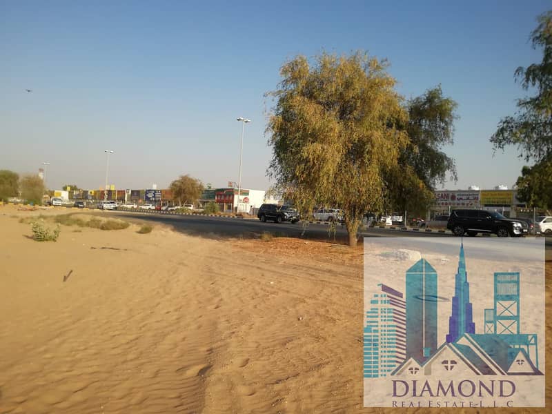 For sale, freehold, the largest plot of residential investment land in Al Helio 2, Ajman, overlooking the main street directly.