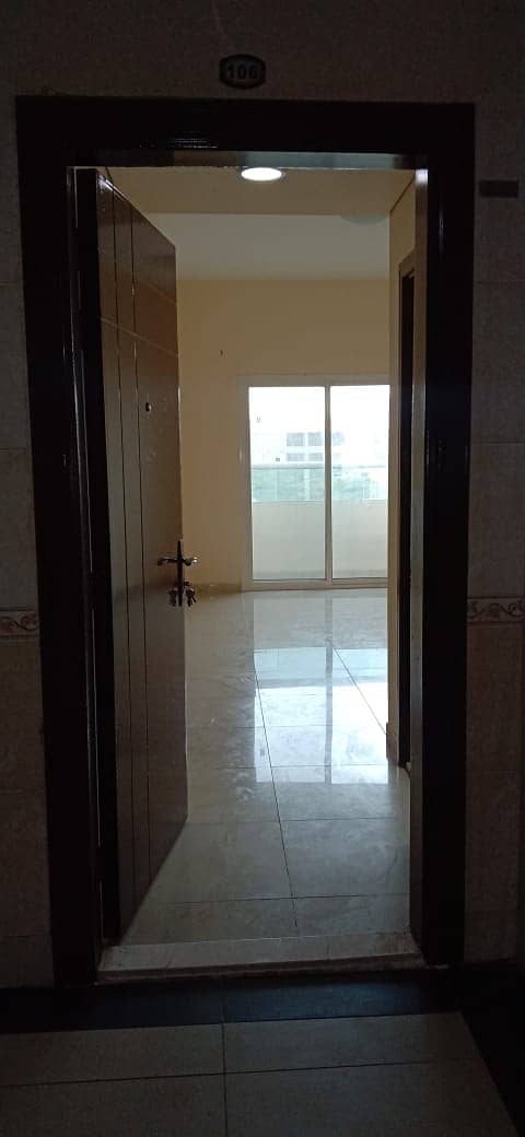 A room and a hall for annual rent at an excellent price, 2 bathrooms, with a balcony with easy access to Dubai