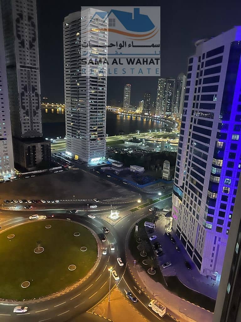 A room and a hall overlooking the lake, a hotel entrance, two bathrooms, a balcony, a view of the sea, kitchen items are available, Sharjah Al Taawun,