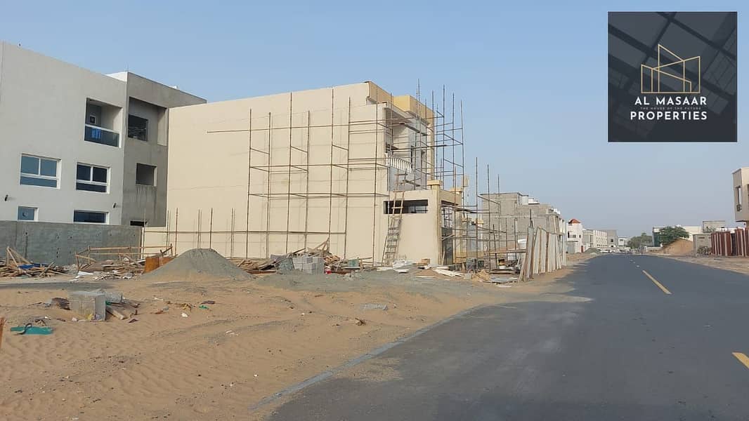 For sale, corner land, two streets, in Ajman, Al Zahia, a very special location, an area of 212 meters, a ground and first permit, at a price of 285 t