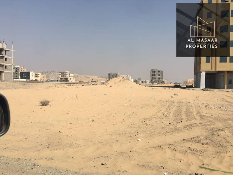 Land for sale in Ajman, Al Hamidiyah, residential, commercial, corner, excellent location, area of 10,000 feet, ground license and 8 floors