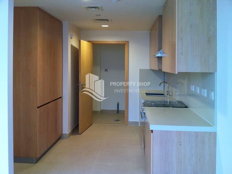 6 2-bedroom-apartment-al-raha-beach-al-ziena-tower-e-kitchen-and-laundry. JPG